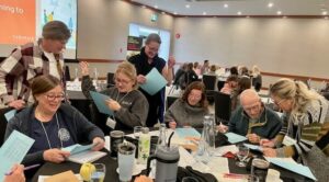 Participants at a table talking.